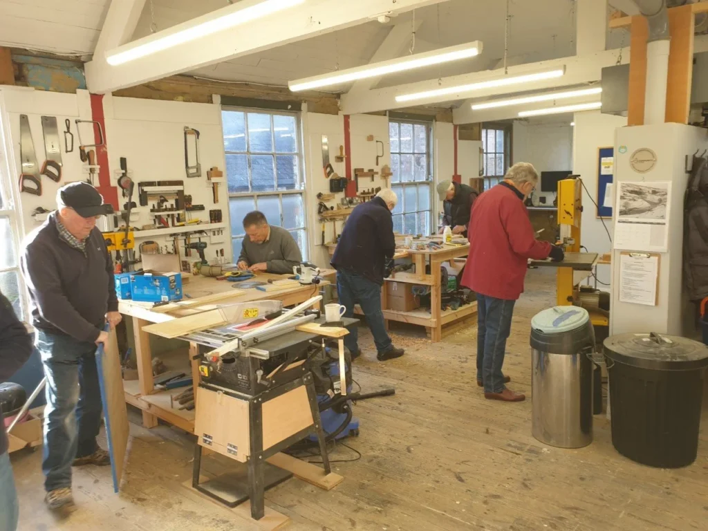 Happy people hard at work in the workshop.